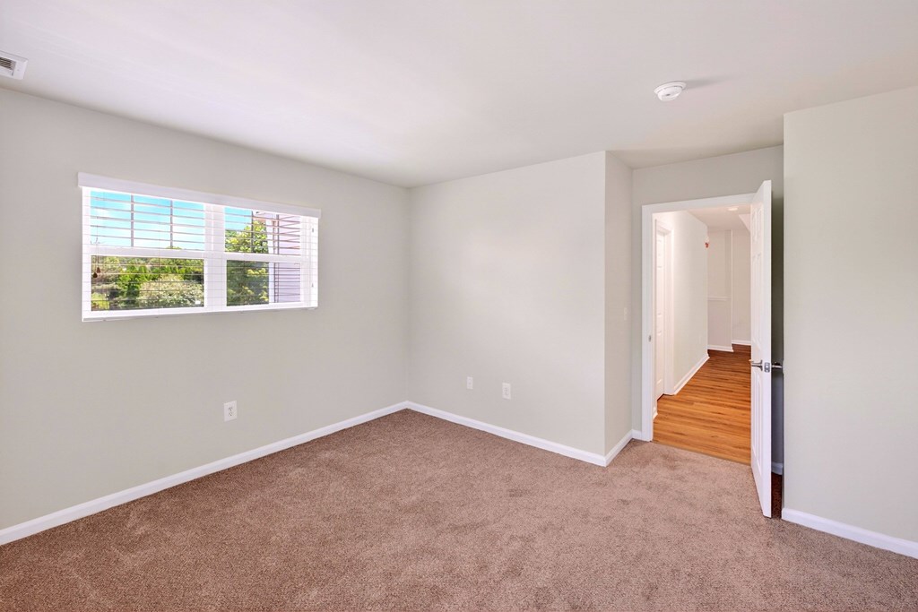 A room with a window and a door.