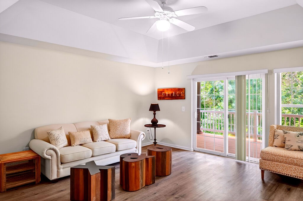 A living room with a white couch and wooden coffee table.