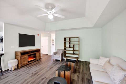A living room with a white couch and a television.