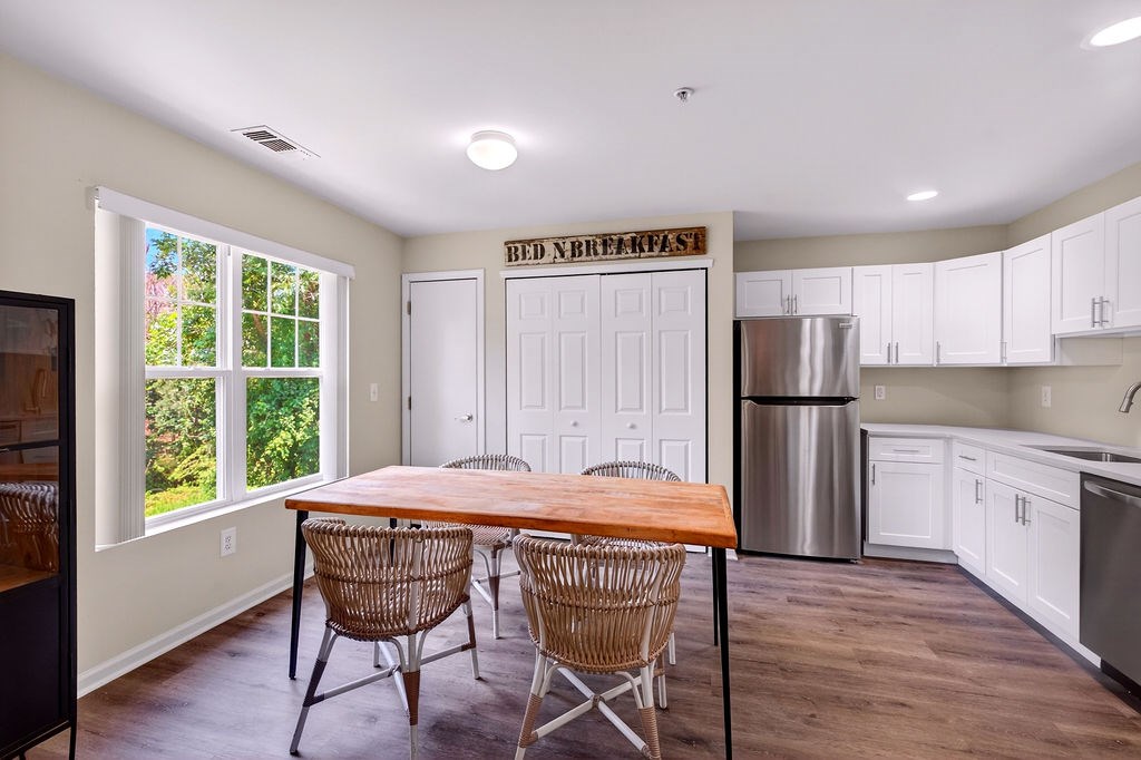 A breakfast nook with a wooden table and chairs.