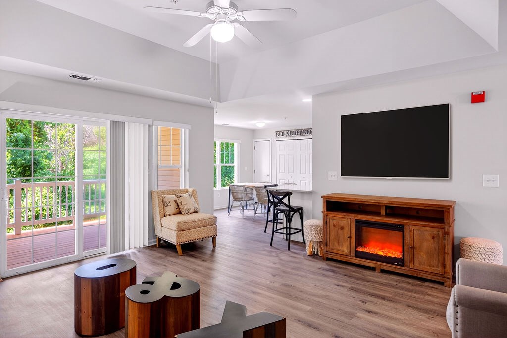 A living room with a fireplace and a flat screen TV.