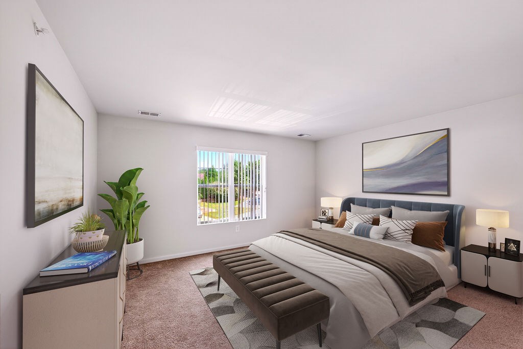 A bedroom with a large bed and a painting on the wall.