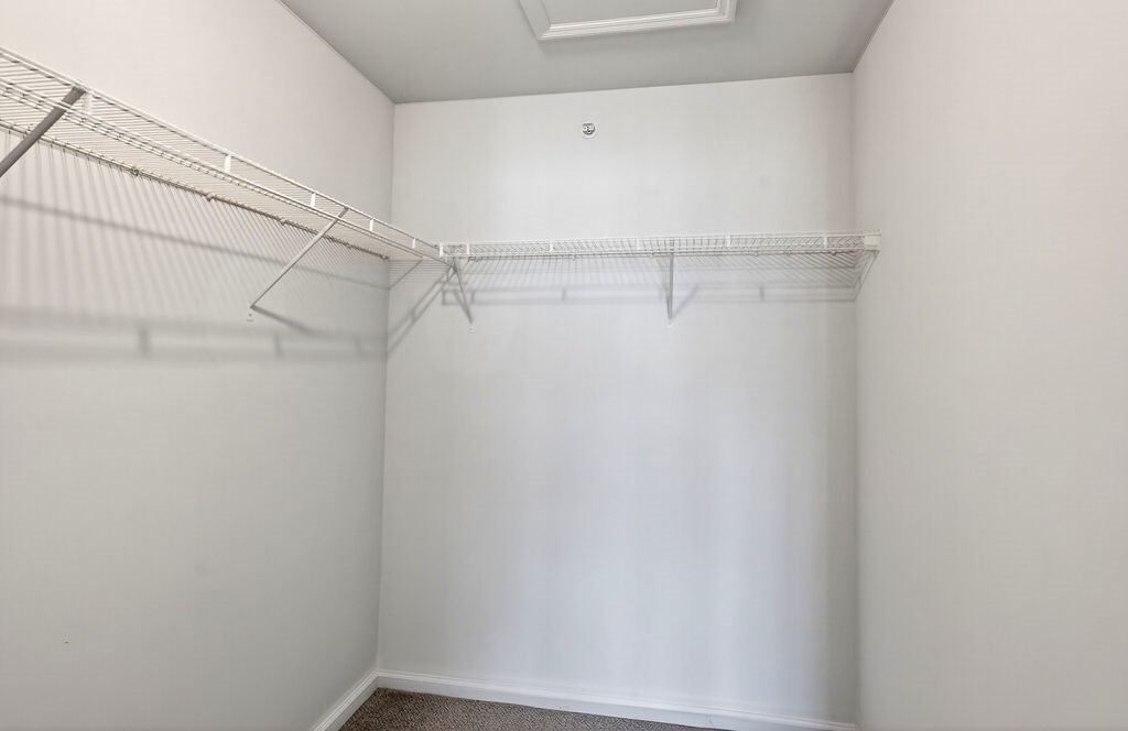 Empty room with white walls and a metal rack on the wall.