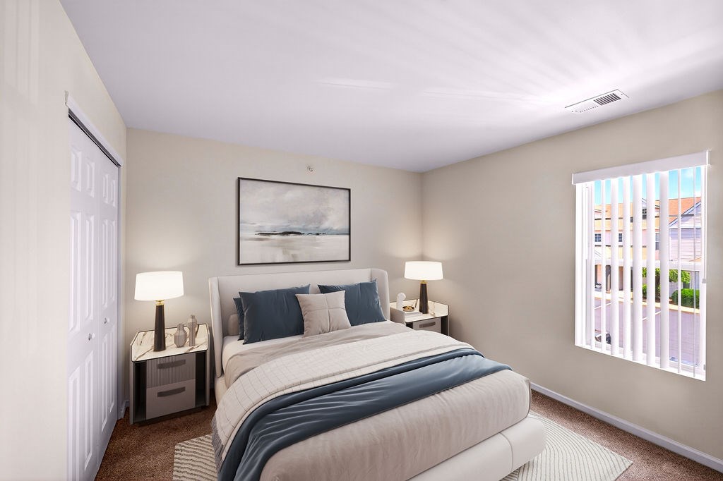 A bedroom with a large bed and a painting on the wall.