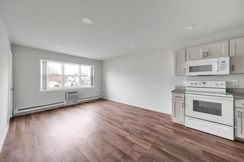 Living room with kitchen at Amity Senior, Amityville, NY