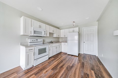 Kitchen with appliances and cabinets at Amity Senior, Amityville, 11701