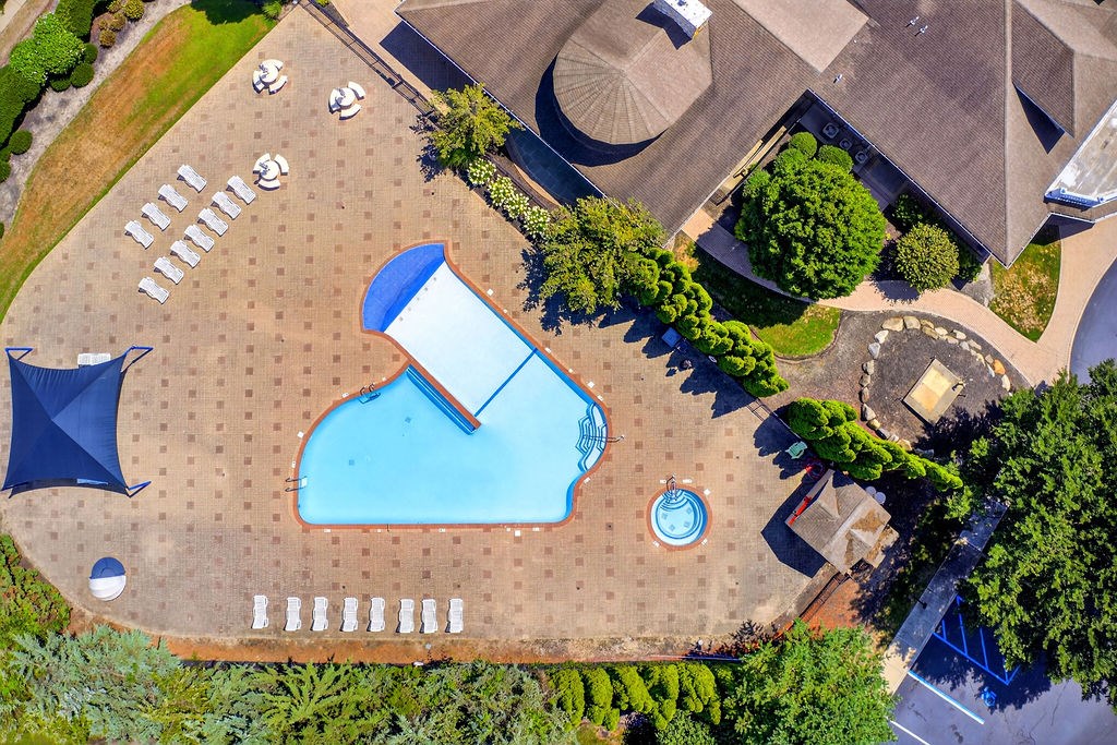 A large swimming pool with a slide and a waterfall.