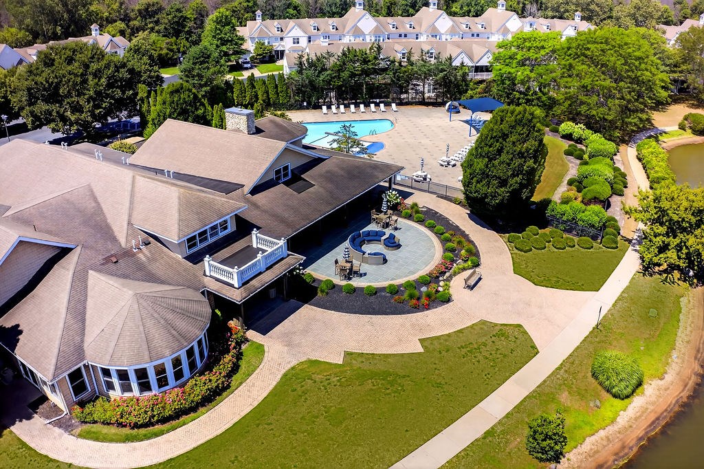 A large building with a round structure in front of it.