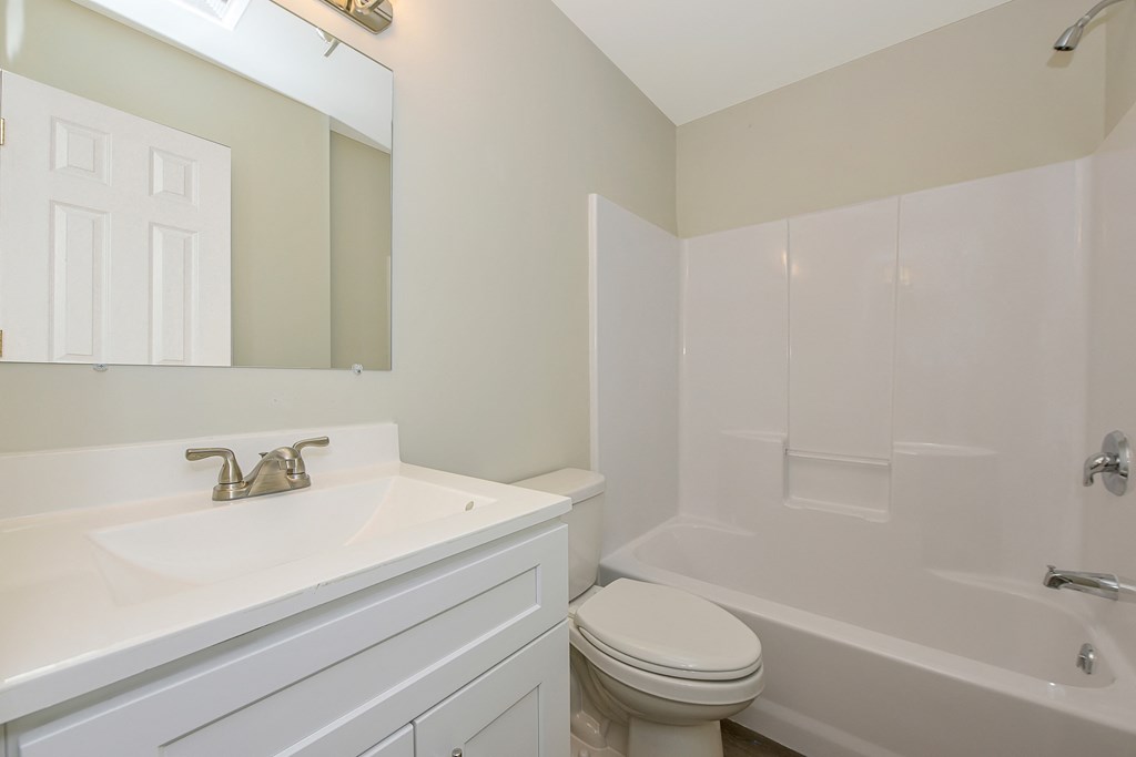 a bathroom with a sink toilet and bathtub  at Platt Gardens, West Babylon