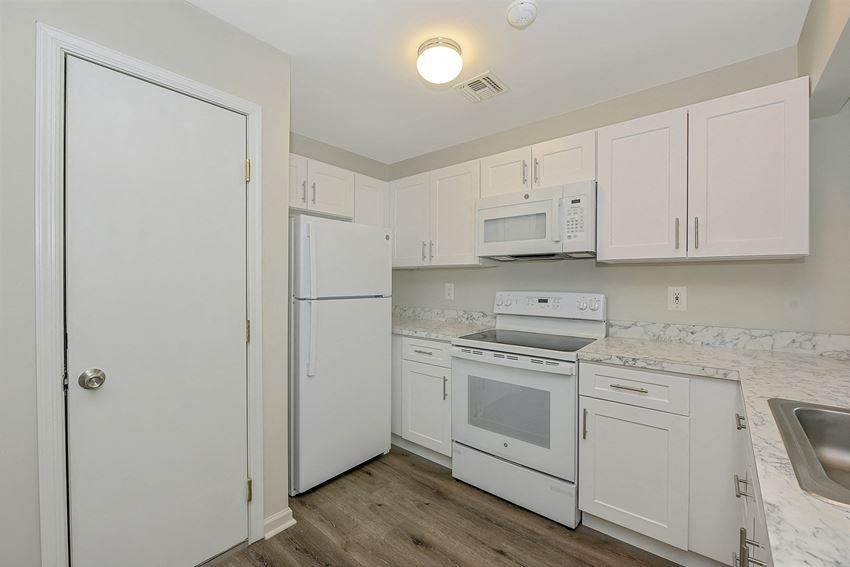 a kitchen with white cabinets and white appliances a kitchen with white cabinets and white appliances at Platt Gardens, West Babylon, 11704