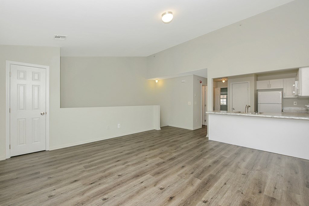 a bedroom with hardwood floors and white walls  at Platt Gardens, West Babylon, NY, 11704