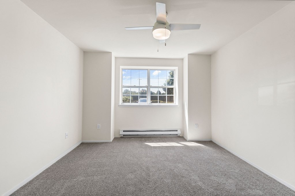 Room with ceiling fan and light and window at Oakwood Manor, Bay Shore, NY