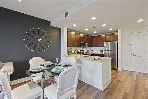 a kitchen and dining room with a table and chairs