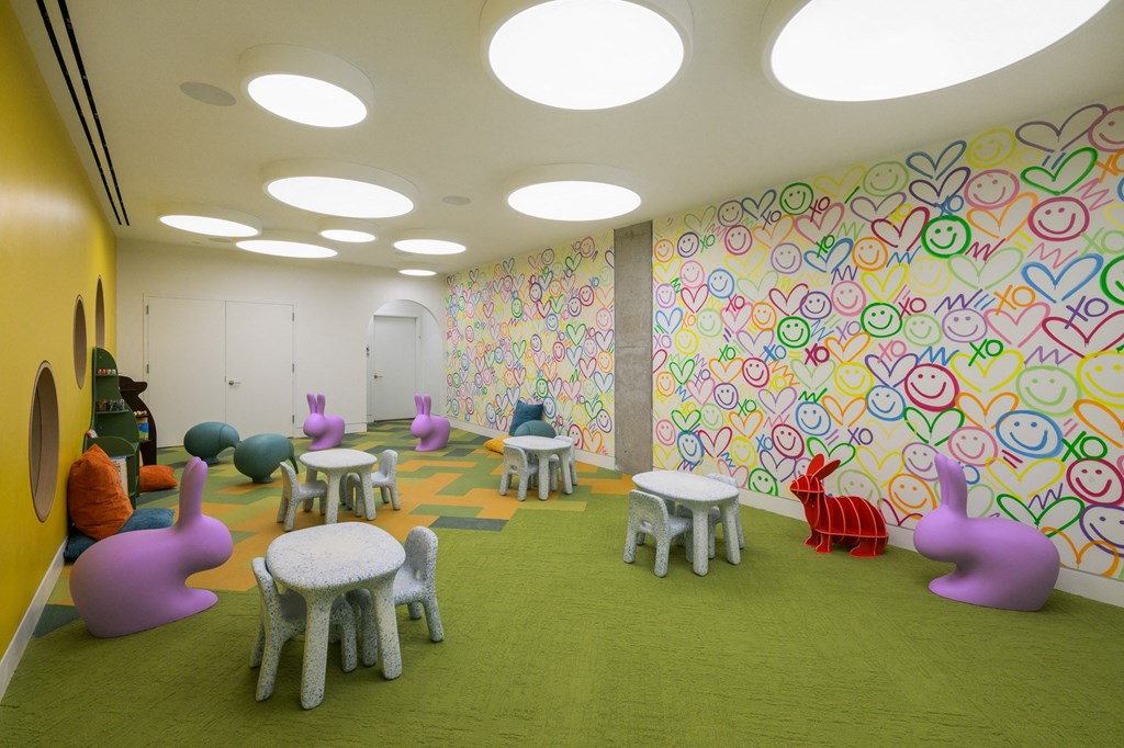 a rendering of a childrens play room with chairs and tables