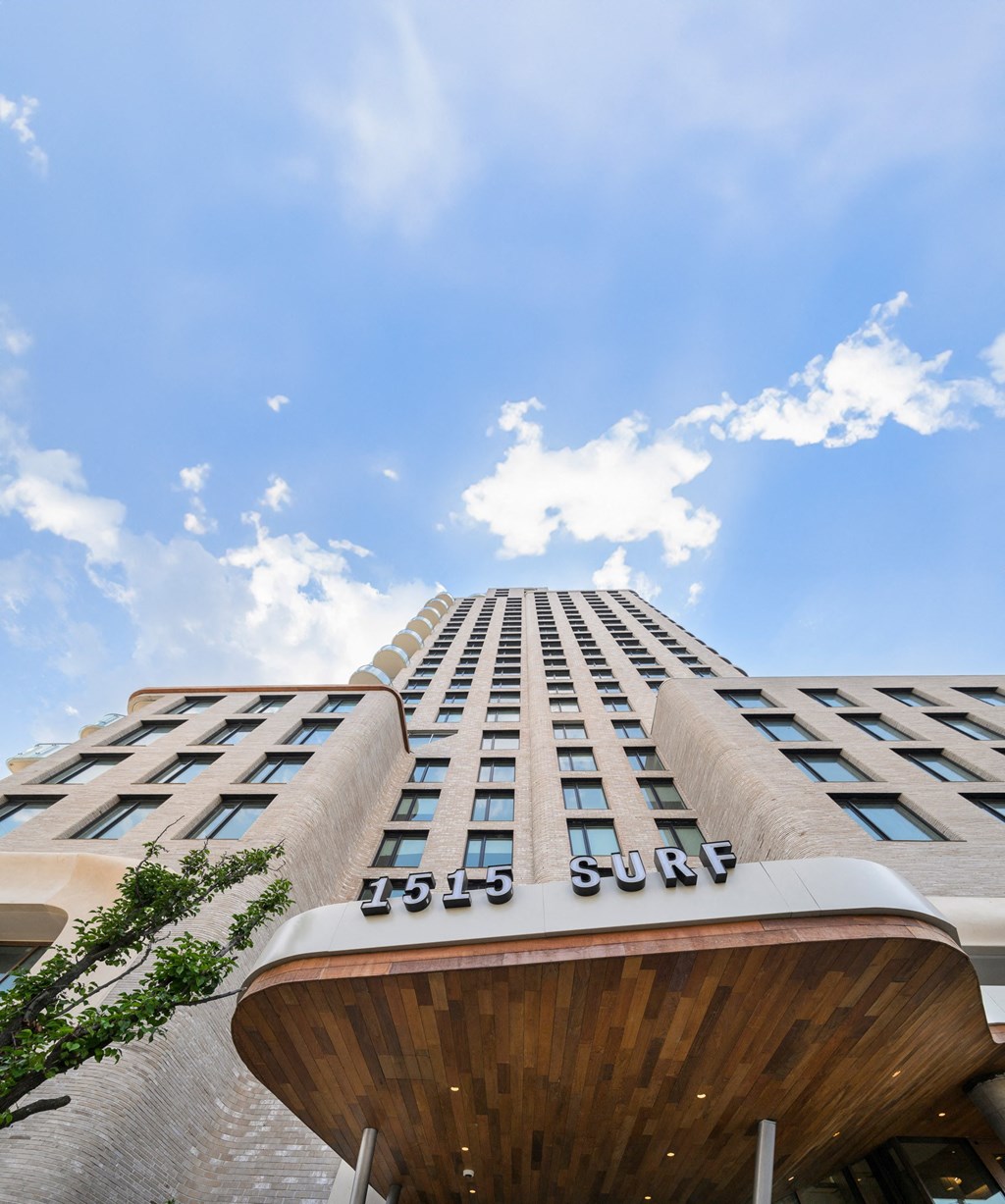 a view of a tall building with a blue sky in the background