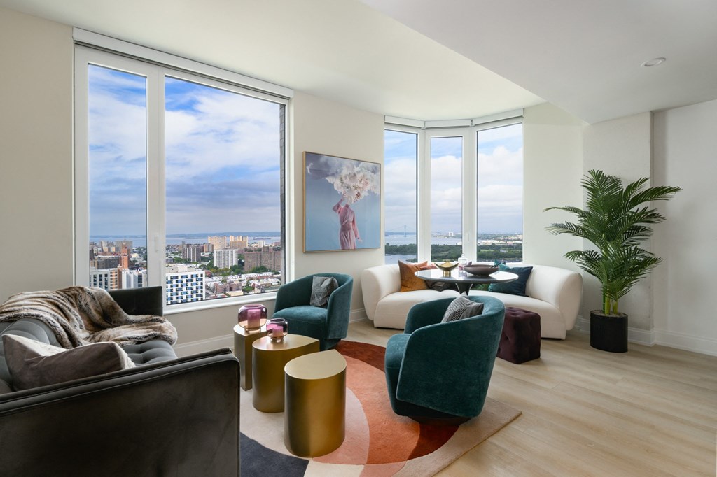 a living room with a view of the city and a large window