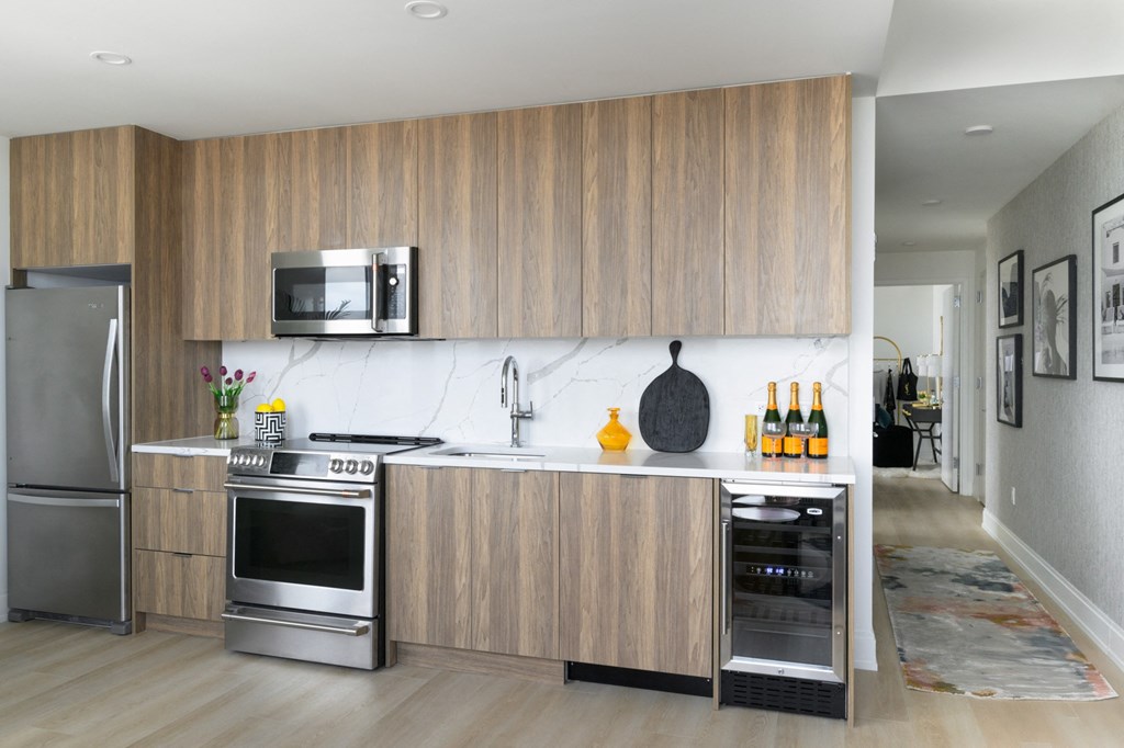 a kitchen with wooden cabinets and stainless steel appliances