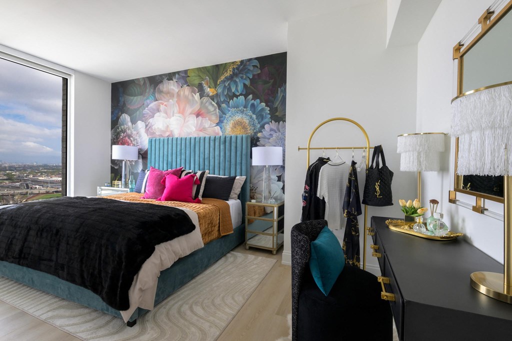 a bedroom with a bed and a large wall mural