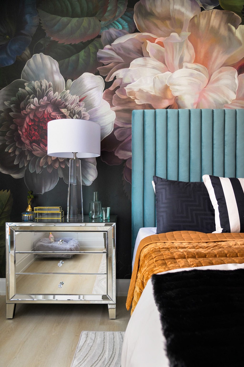 a bedroom with a bed and a painting on the wall