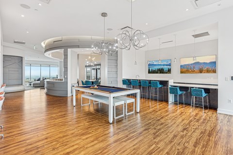 A modern dining room with a large table and chairs.