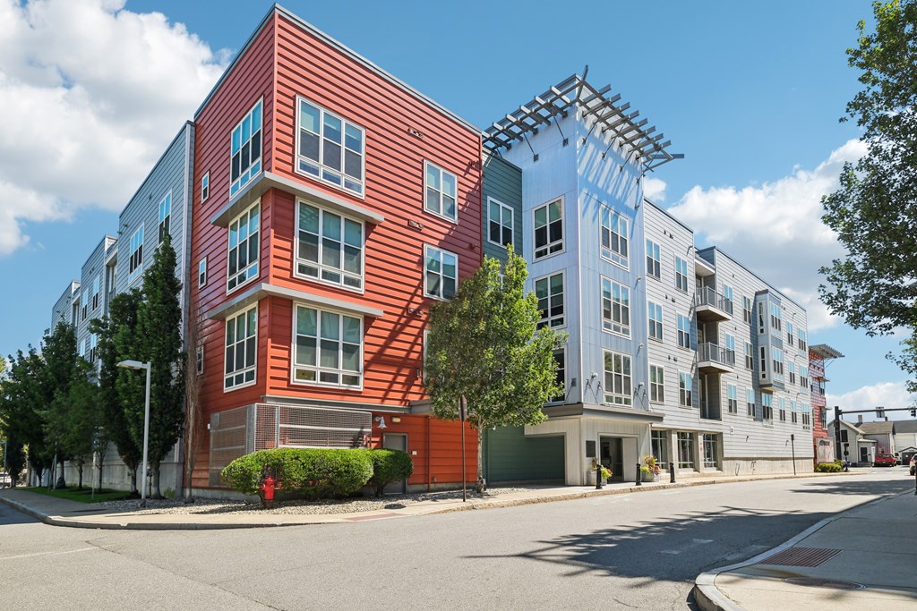 A red building with a white building behind it.