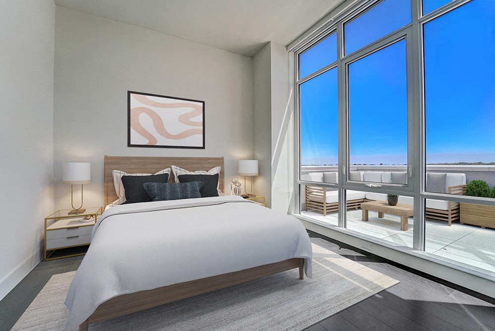 penthouse primary bedroom with a large bed and floor-to-ceiling windowsat Continuum, White Plains, NY