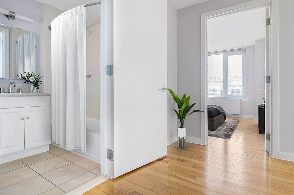 a living room with white walls and a bamboo floor