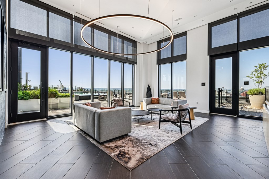 A modern living room with a large window overlooking the ocean.