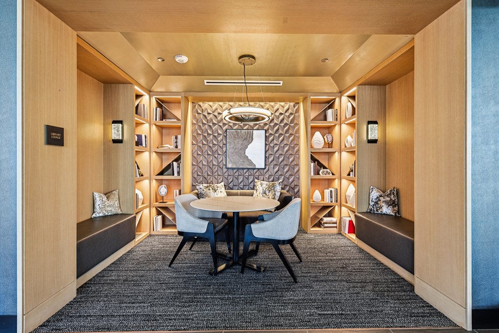 A modern dining room with a round table and chairs.
