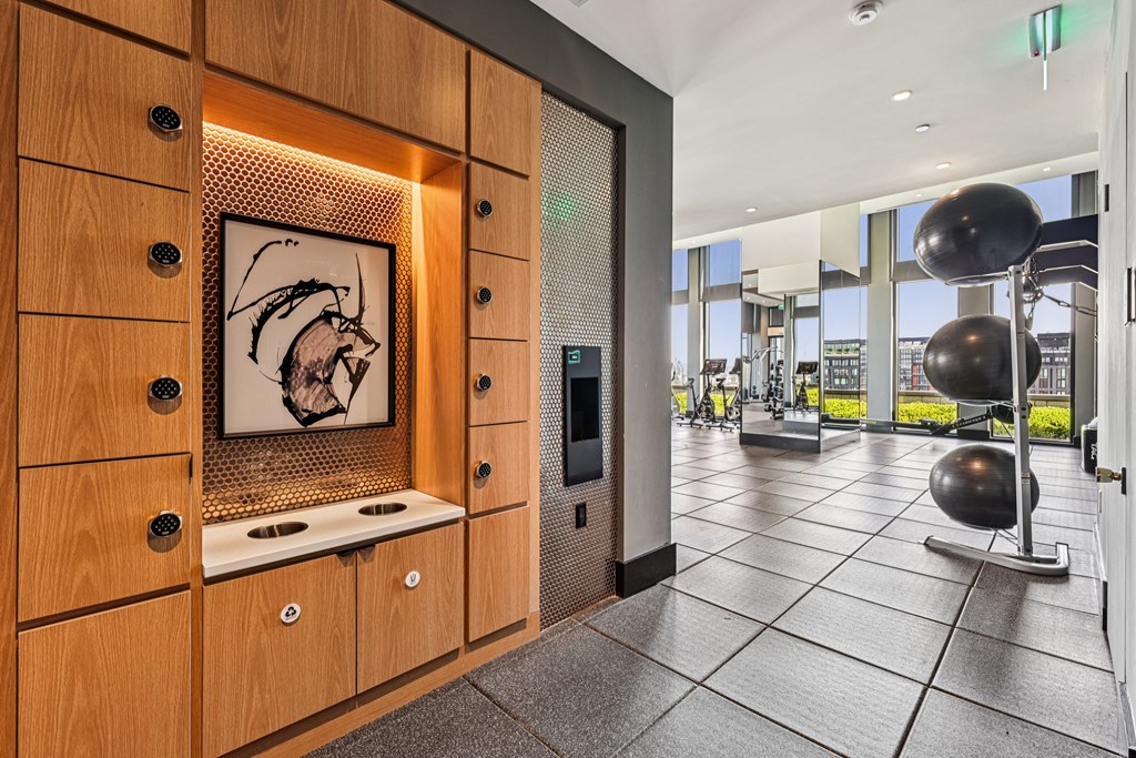 A modern kitchen with wooden cabinets and a fridge.