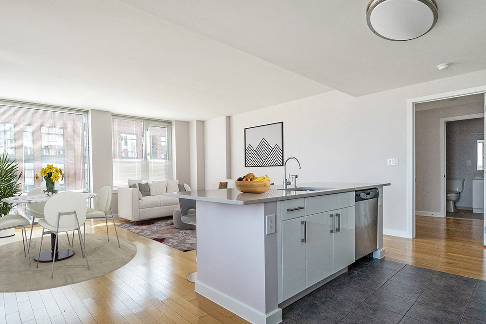 a kitchen with a island and a living room with a couch at 34 Berry, Brooklyn, NY