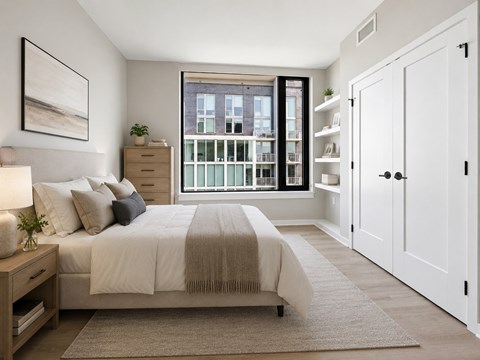 A bedroom with a large bed and a view of a cityscape through the window.