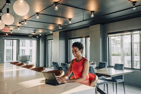 a woman sitting at a table with a laptop