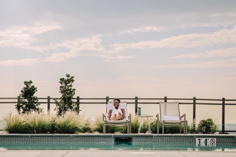 a man sitting in a chair next to a pool