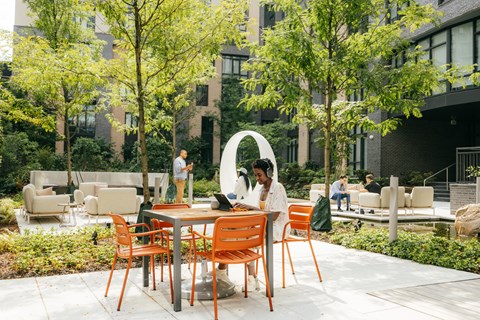 a man sitting at a table with a laptop