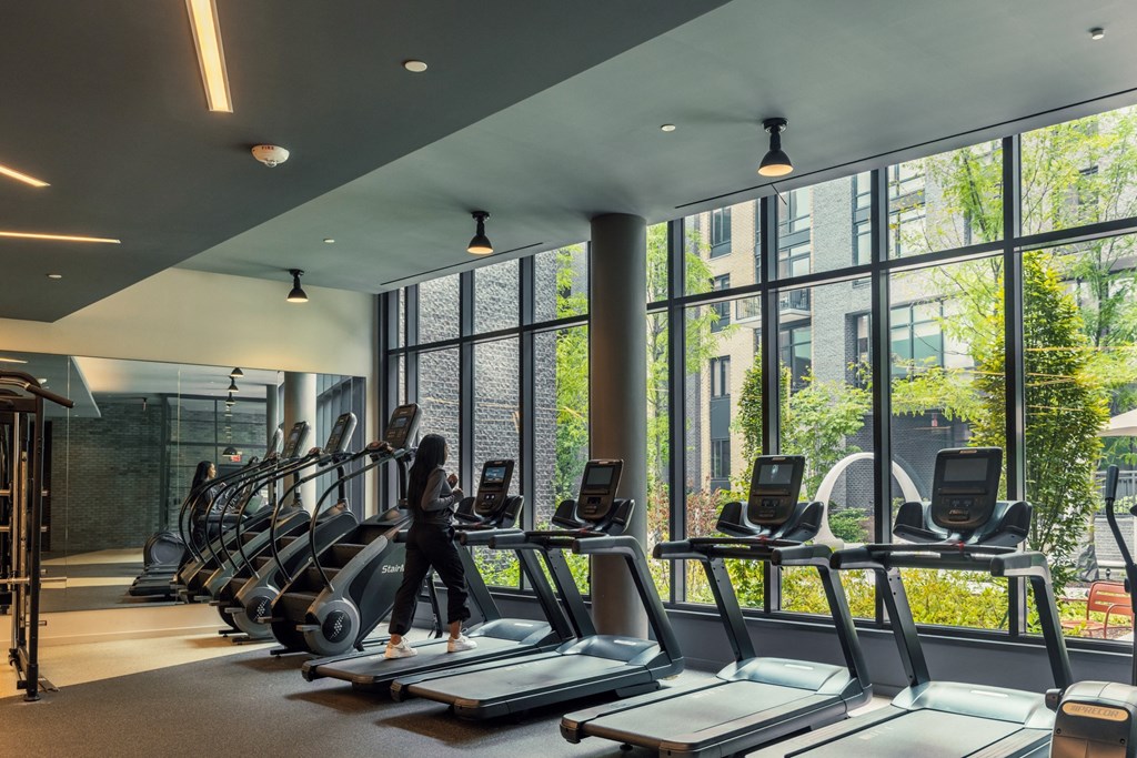 a woman walking on a treadmill in a gym