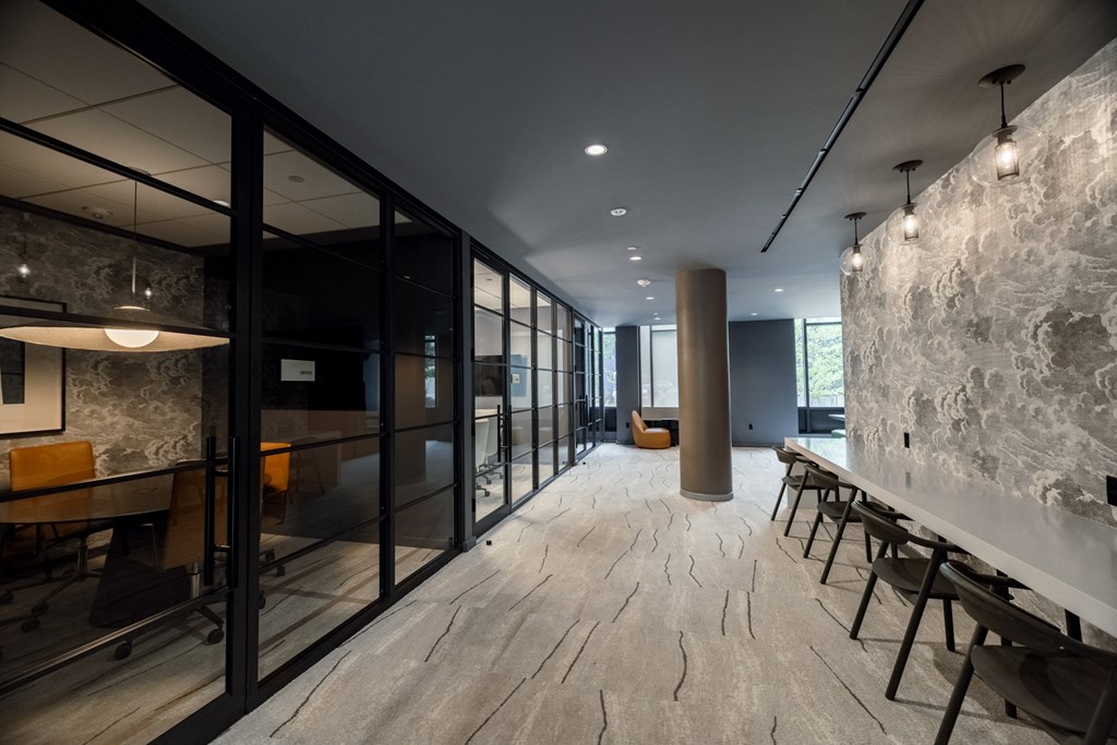 a meeting room with a long table and chairs