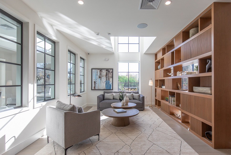 A living room with a couch, a coffee table, and a bookshelf.
