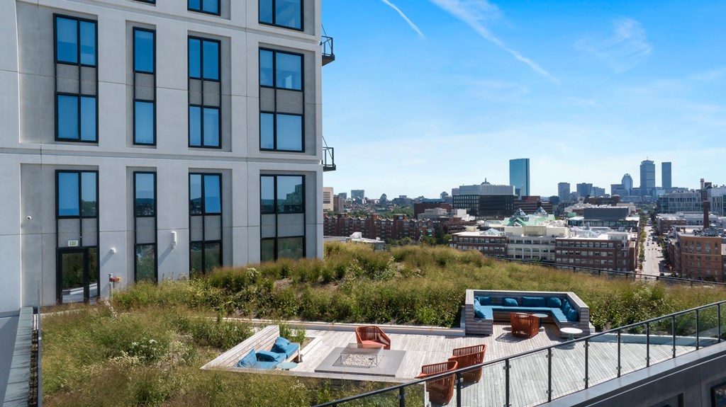 a rooftop terrace with a view of the city