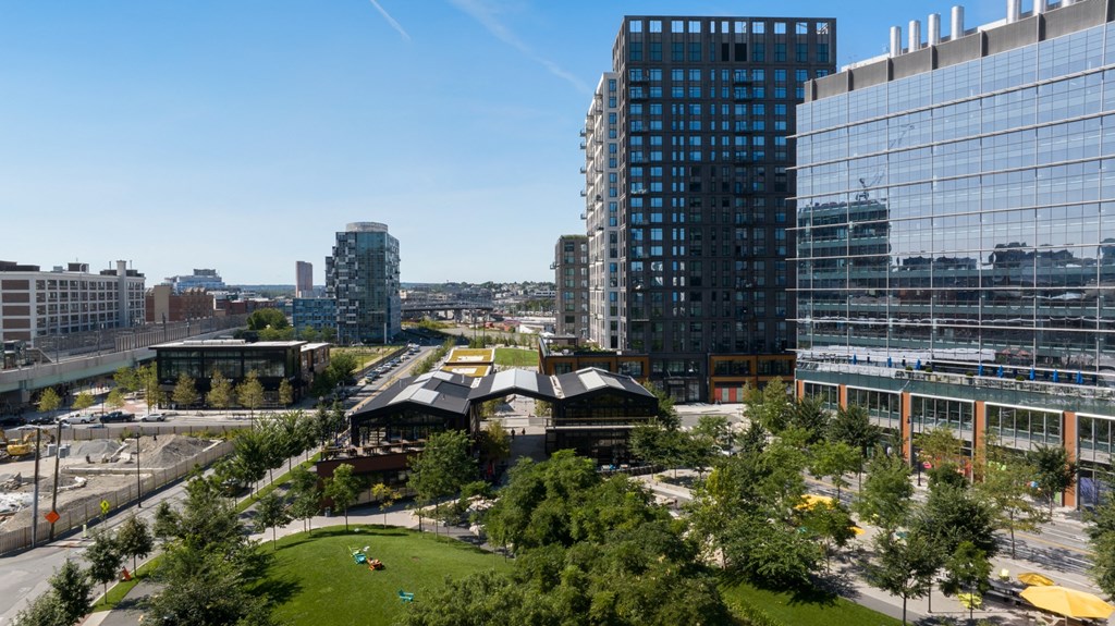 a park in the middle of a city with tall buildings