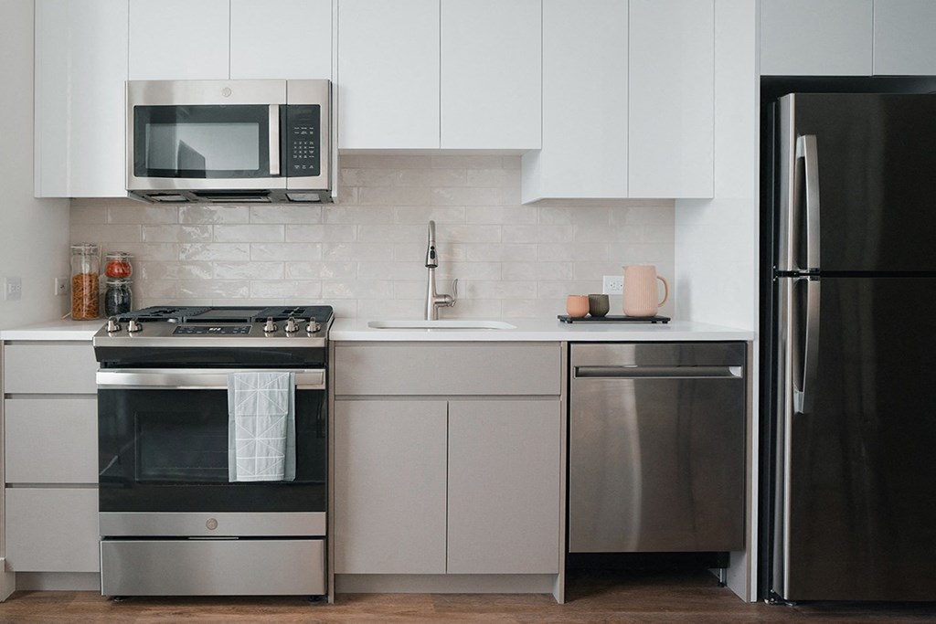 a kitchen with stainless steel appliances and white cabinets