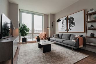a living room with a couch and a coffee table and a window