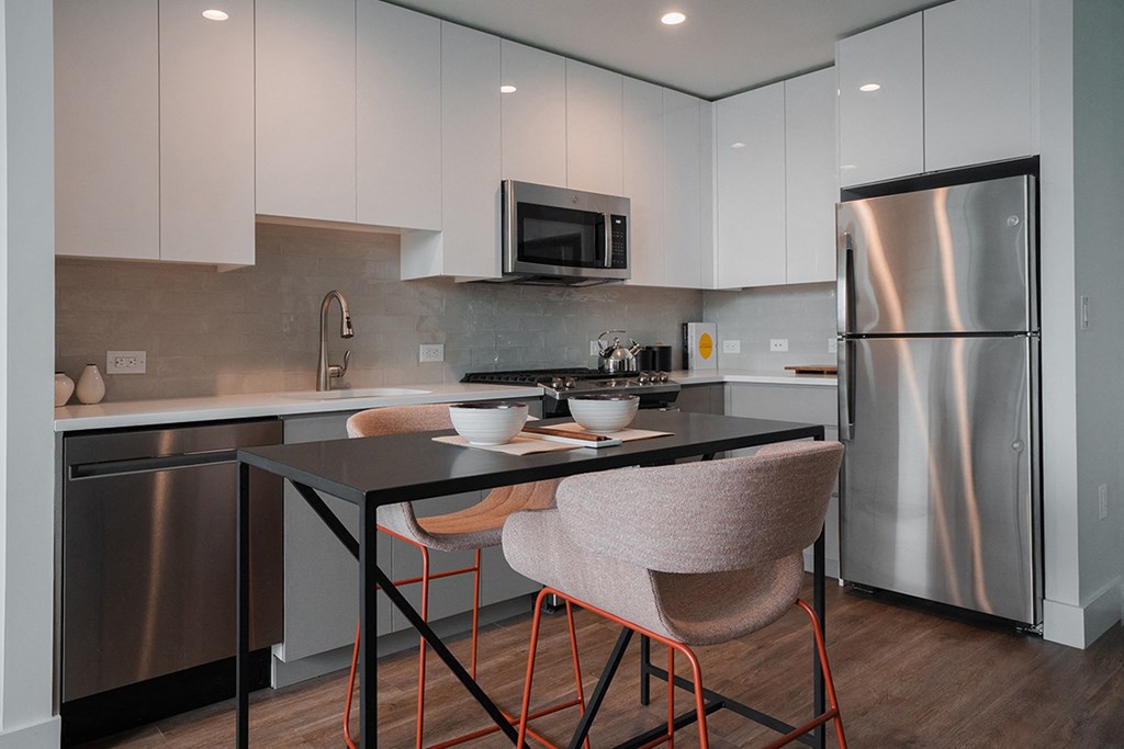 a kitchen with stainless steel appliances and a black counter top