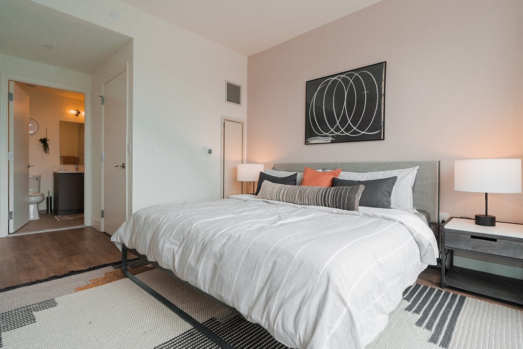 a bedroom with a large bed and a bathroom