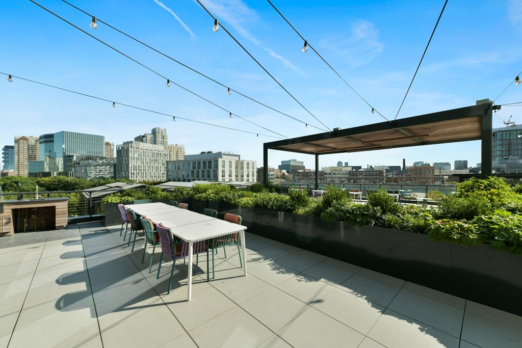 a patio with a table and chairs and a city in the background