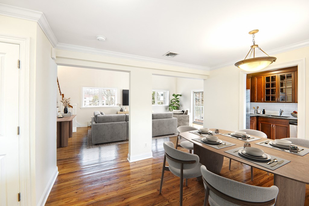 a dining room and living room with a table and chairs