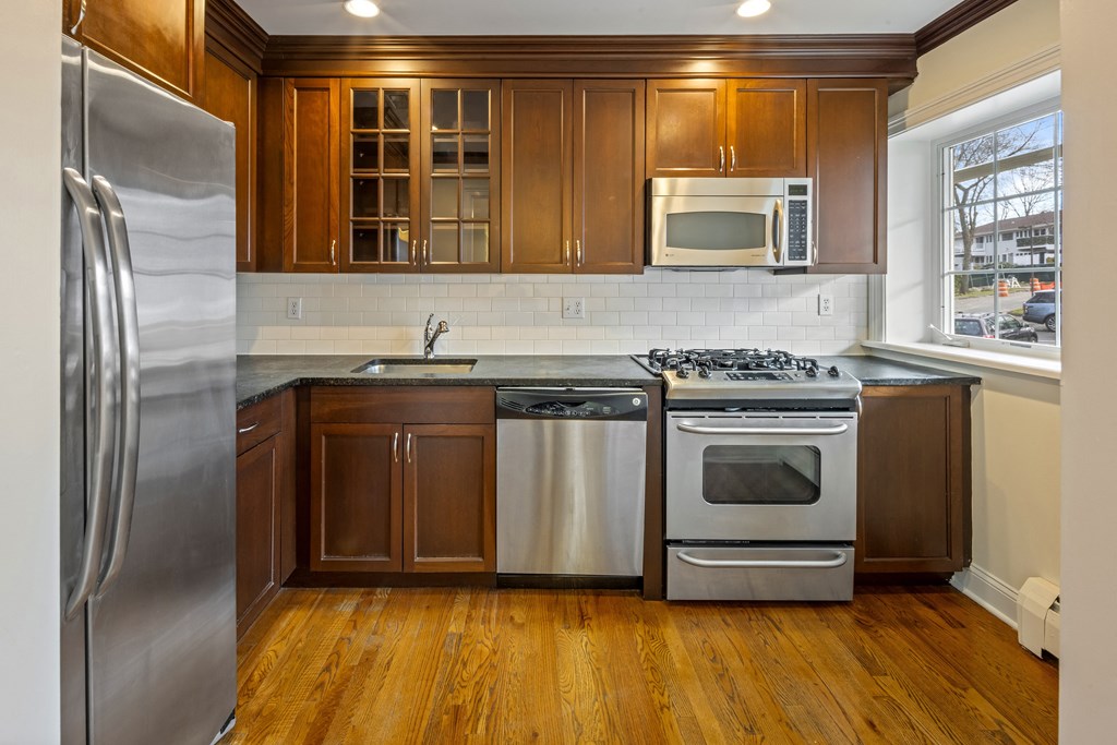 a kitchen with stainless steel appliances and wooden cabinets