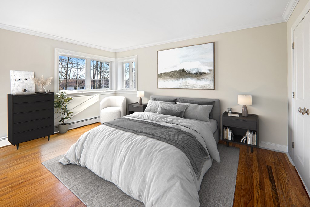 a bedroom with a bed and two windows