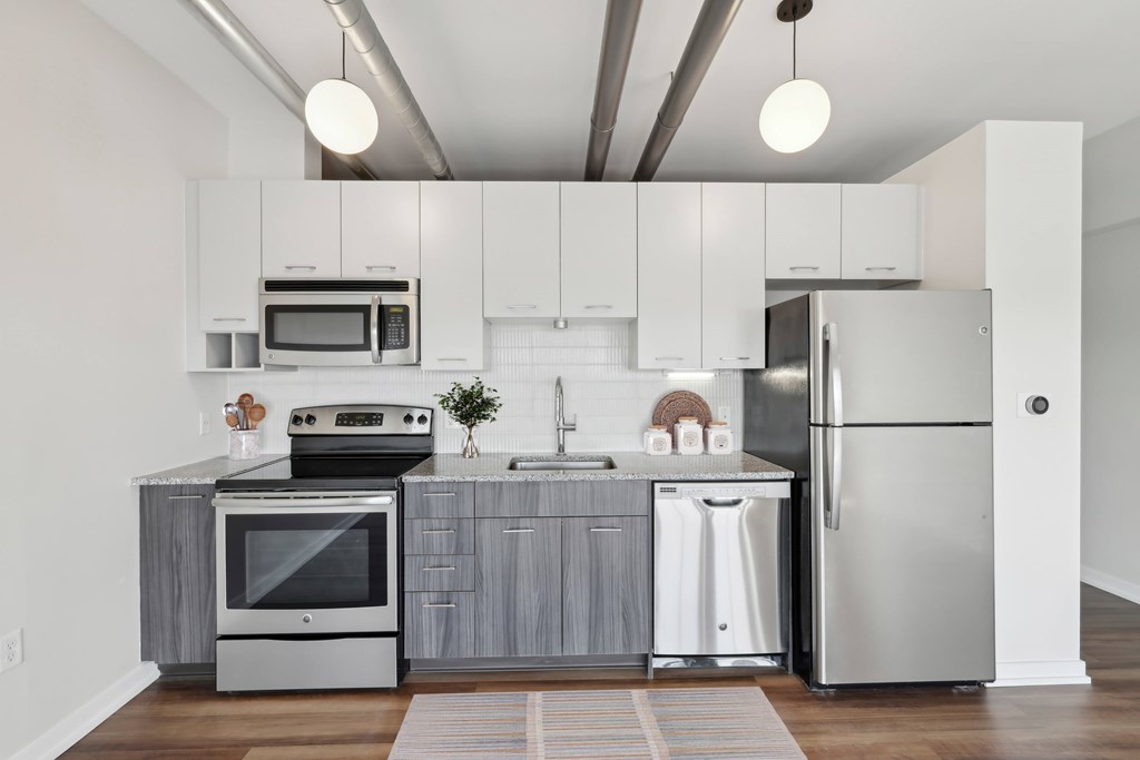 A modern kitchen with stainless steel appliances and wooden cabinets.