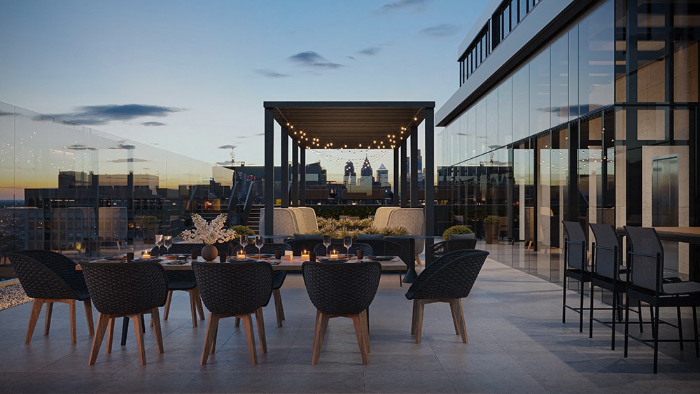 The Sky Deck - Featuring an outdoor terrace with a long table and chairs and a city skyline in the background